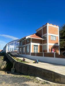 a large building with a glass roof on a street at Finca el porvenir in Sasaima