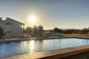 a large swimming pool in front of a house at PoolParadise Tu mejor opción in San Jorge