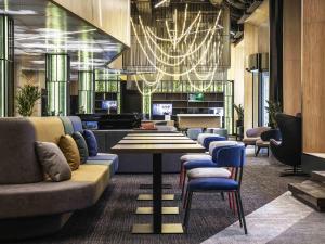 a lobby with couches and a table and chairs at ibis Almaty Jetisu in Almaty +92 photos