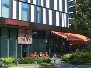 a restaurant with motorcycles parked outside of a building at ibis Almaty Jetisu in Almaty