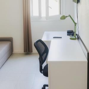 an office with a white desk and a chair at Small functional cocoon Ideal solution for students or professionals in Vaise