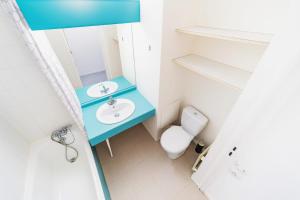 a bathroom with a blue sink and a toilet at Small functional cocoon Ideal solution for students or professionals in Vaise