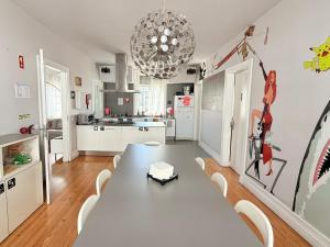 a dining room with a table and a kitchen at Rivoli Cinema Hostel in Porto