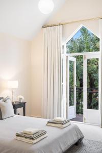 a bedroom with a bed with two towels on it at North Adelaide Townhouse in North Adelaide