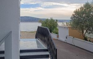 a staircase leading to a balcony with a view of the water at 2 Bedroom Awesome Apartment In Seline in Jurlina +6 photos