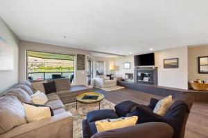 a living room with two couches and a tv at Sunsets at Lake Chelan Petersons #324 in Chelan