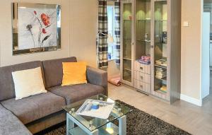 a living room with a couch and some glass cabinets at 2 Bedroom Cozy Home In Lindesnes in Spangereid