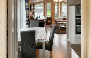 a kitchen and dining room with a table and chairs at 2 Bedroom Cozy Home In Lindesnes in Spangereid