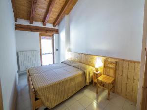 a bedroom with a bed and a lamp on a table at Apartment in Antey-Saint-André near Ski Lifts in Antey-Saint-André