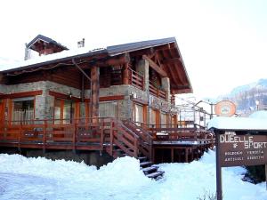 a log cabin with a sign in the snow at Apartment in Antey-Saint-André near Ski Lifts in Antey-Saint-André +32 photos