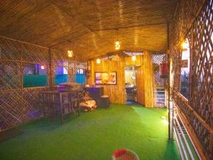 an inside view of a room with green grass at Blissful Mountain Kyarki in Shivpuri