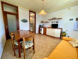 ポルト・サンタ・マルゲリータ・ディ・カオルレにあるComfortable villa near the beachのテーブルとキッチンのあるリビングルーム