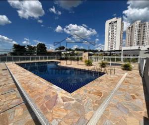 a swimming pool on top of a building at Flat Maya in Barretos