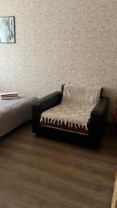 een stoel in een kamer met een muur bij Imantas in Daugavpils