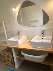 a bathroom with two sinks and a mirror at chateaugite in Pontlevoy +13 photos