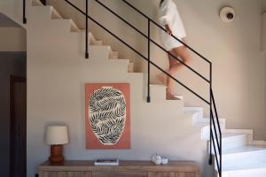 a person walking up the stairs in a house at Arcasa Villas Collection by Omilos Hotels in Archanes