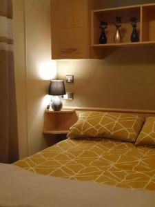 a bedroom with a bed with a lamp and a bed sidx sidx sidx at Cala Gran Holiday Park - Holiday Accommodation 10830 in Fleetwood +8 photos
