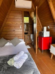 Un dormitorio con una cama en una cabaña de madera. en Chalés SKYCHALES, en Governador Valadares