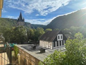 a black and white building with a church in the background at H24 Parkhotel Thale in Thale