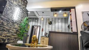 a lobby with a fountain in the middle of a room at Jayhaven Crystal Serviced Apartment in Uyo +84 photos