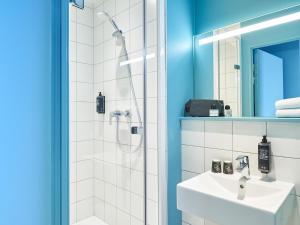 a bathroom with a shower and a sink at ibis budget Nancy Laxou in Nancy +44 photos