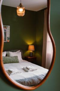 a reflection of a bed in a mirror at Casa d'Avo - 3BD cosy home in Funchal +40 photos
