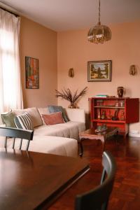 a living room with a couch and a table at Casa d'Avo - 3BD cosy home in Funchal