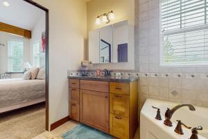 a bathroom with a sink and a tub and a bed at House at Eagle Creek in Leavenworth +21 photos