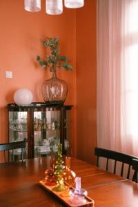 a dining room table with a vase on top of it at Casa d'Avo - 3BD cosy home in Funchal