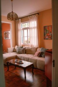a living room with a couch and a coffee table at Casa d'Avo - 3BD cosy home in Funchal