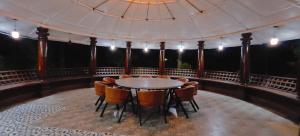 a room with a table and chairs in a tent at Vintage Trails By Ilara in Alūr +247 photos