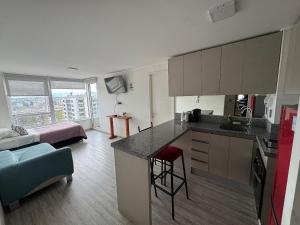 a kitchen and a living room with a kitchen and a living room at Edificio Stepke in Temuco