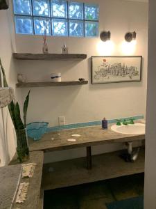 a bathroom with a counter and a sink and a window at Espaço Spa in Sao Paulo
