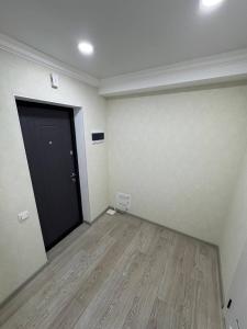 a room with a black door and a wooden floor at Panorama view apartament tolstoi str in Chişinău