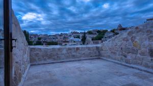 a stone wall with a view of a city at Anjelic Cave Cappadocia in Urgup