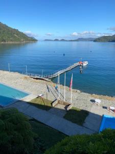 a dock on a body of water with a boat at Hotel Termas de Llancahué 