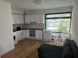 a kitchen with a couch and a table in a room at Mulligan Hotel in Dublin