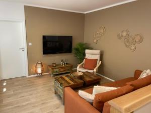 a living room with a couch and a flat screen tv at Ubytování u Lupína in Lužice
