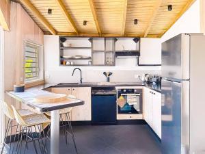 a kitchen with a sink and a refrigerator at Villa Olive Sea View Cocoon in Oyster Pond in Oyster Pond