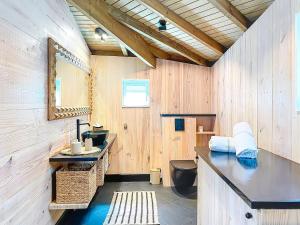 a bathroom with a sink and a toilet and a mirror at Villa Olive Sea View Cocoon in Oyster Pond in Oyster Pond +3 photos