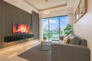 a living room with a couch and a tv at Upscale Condo, Spectacular Views in Carlos Guerra