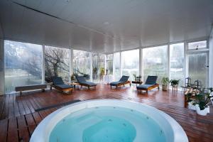 a large room with a hot tub in a building at Pioneros Suites by Grupo Tierra Gaucha in San Carlos de Bariloche +88 photos