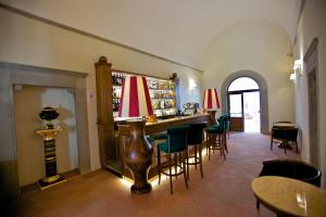 a bar in a restaurant with chairs and tables at Villa Tolomei Hotel & Resort in Florence