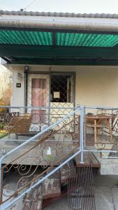 a balcony of a house with a green awning at Gárdonyi kisház in Gárdony