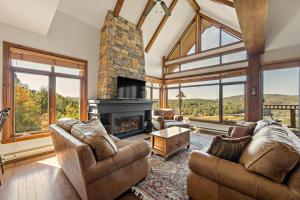 a living room with two couches and a fireplace at Tremblant Prestige - Altitude 172-11 in Mont-Tremblant +25 photos