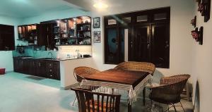 a kitchen with a table and chairs and a sink at Siri Villa Kandy in Kandy