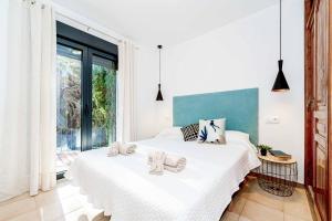 a bedroom with two beds and a large window at Villa Abeto in El Tosalet +15 photos
