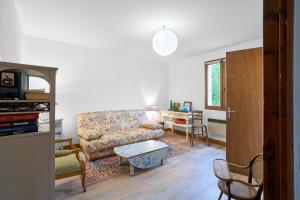 a living room with a couch and a table at Maison La Plaine, En Périgord in Saint-Laurent-la-Vallée