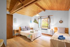 a bedroom with two beds and a window at Maison La Plaine, En Périgord in Saint-Laurent-la-Vallée