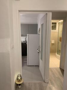 an open door to a kitchen with a refrigerator at Gite d'Oliva St Gervais in Saint-Gervais-la-Forêt +3 photos